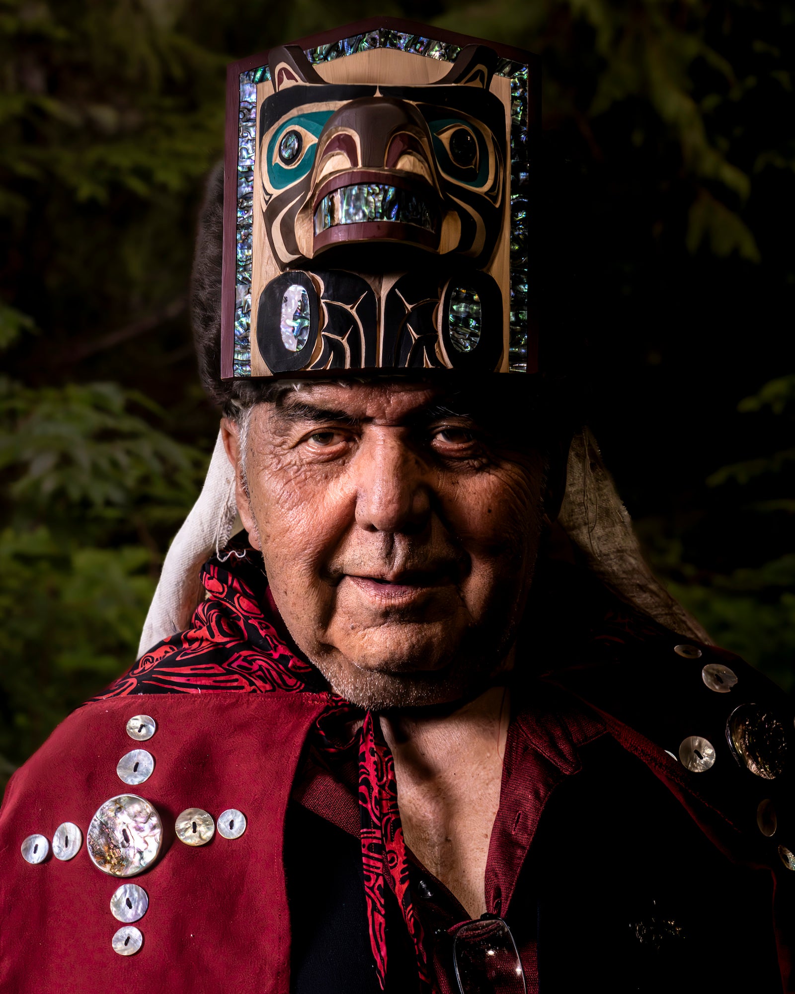 Portrait of an Indigenous elder wearing a carved abalone-inlaid frontlet headdress and a red button blanket robe. Photo by Jack Plant. Alpha 1. 24-105mm f/4 G. 1/50-sec., f/6.3, ISO 3200. Portrait of an Indigenous elder wearing a carved abalone-inlaid frontlet headdress and a red button blanket robe. Photo by Jack Plant. Alpha 1. 24-105mm f/4 G. 1/50-sec., f/6.3, ISO 3200.