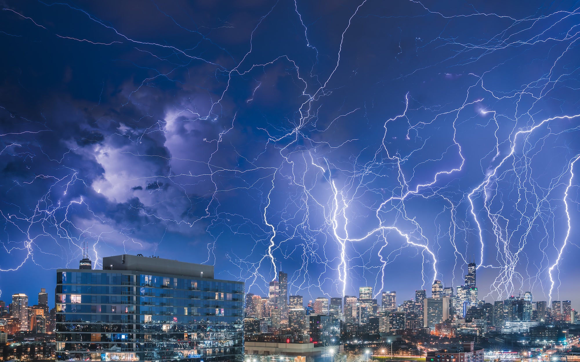 Composites of lightning strikes fill the sky above the Chicago skyline.