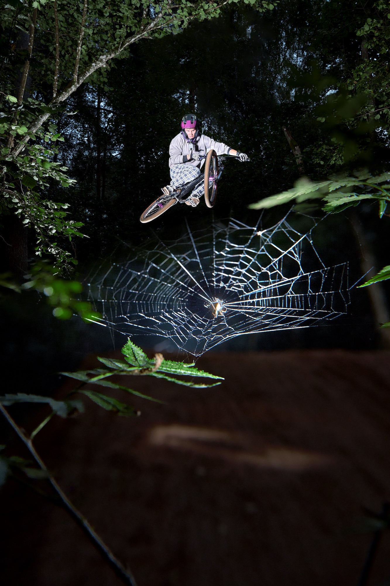 Mountain biker jumping over spider web