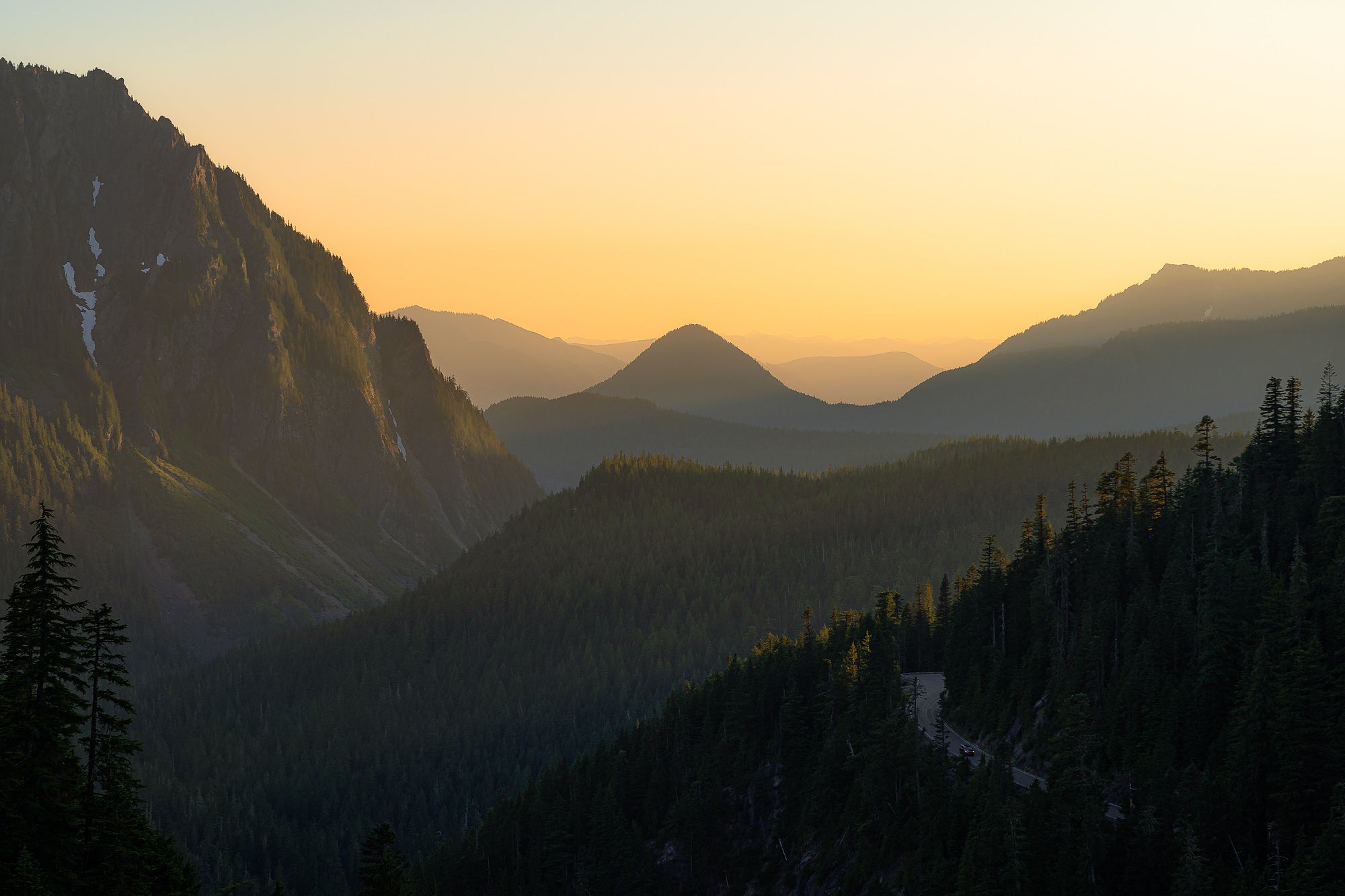 A golden sunset glowing on the hills inside Mount Rainier National Park in Washington State. Photo by Dylan McMains. Sony Alpha 7 III. Sony 24-105mm f/4 G. 1/160-sec., f/8, ISO 100