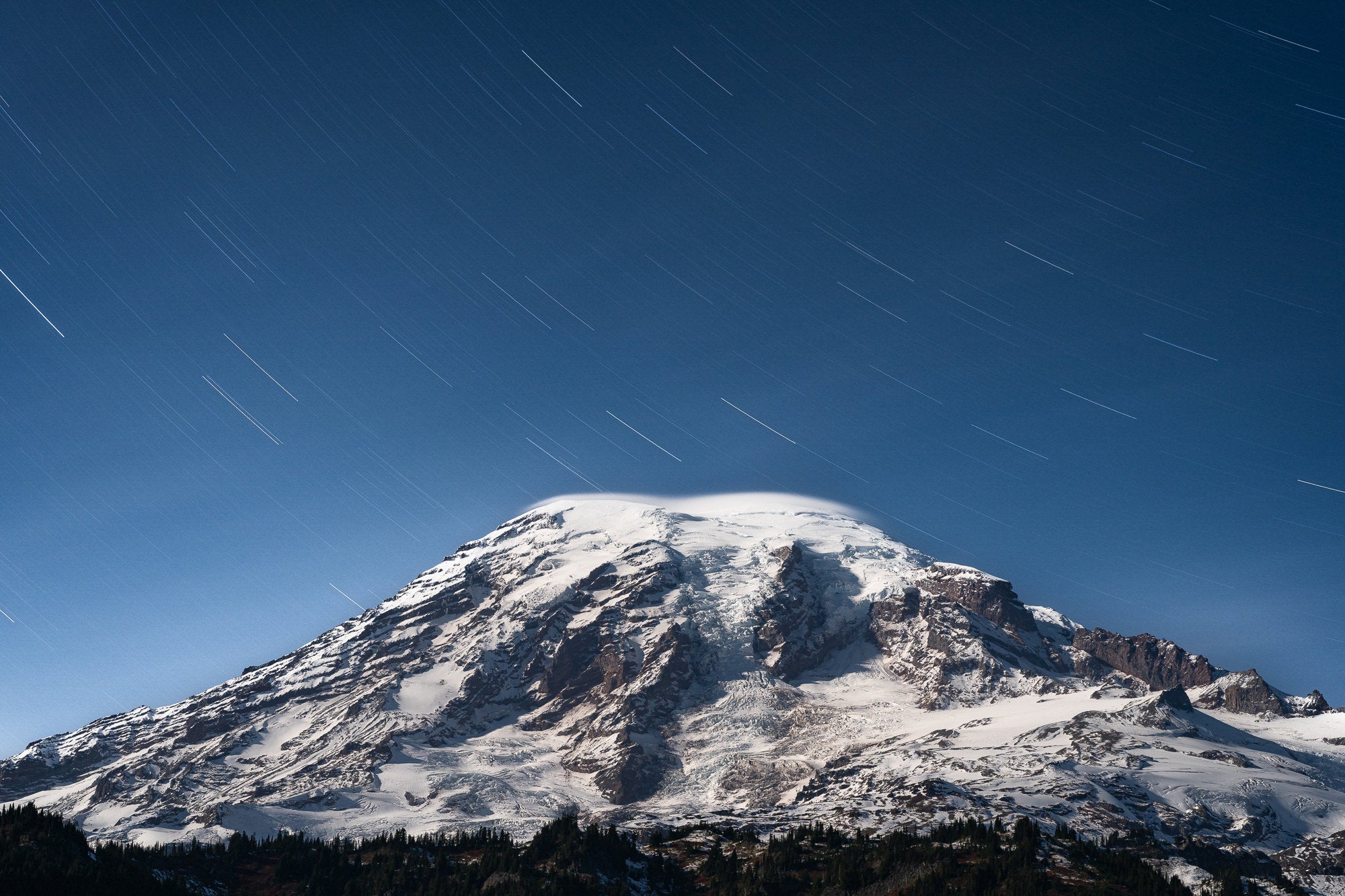A long exposure image of the stars in motion above Mount Rainier, illuminated only by moonlight. Photo by Dylan McMains. Sony Alpha 7 III. Sony 24-105 f/4 G. 40-min, f/11, ISO 100