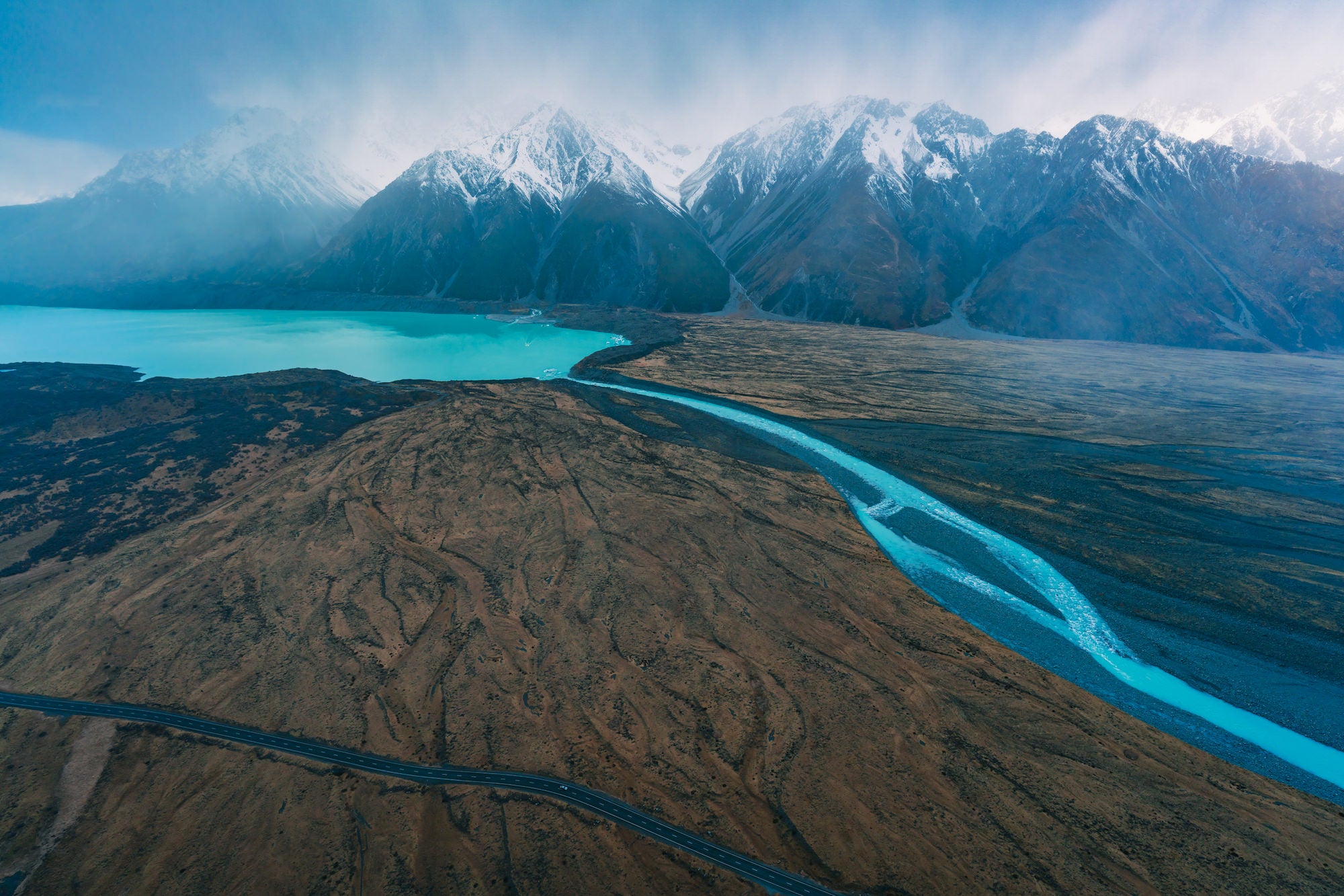 Blue lake in front of snowy mountainscape