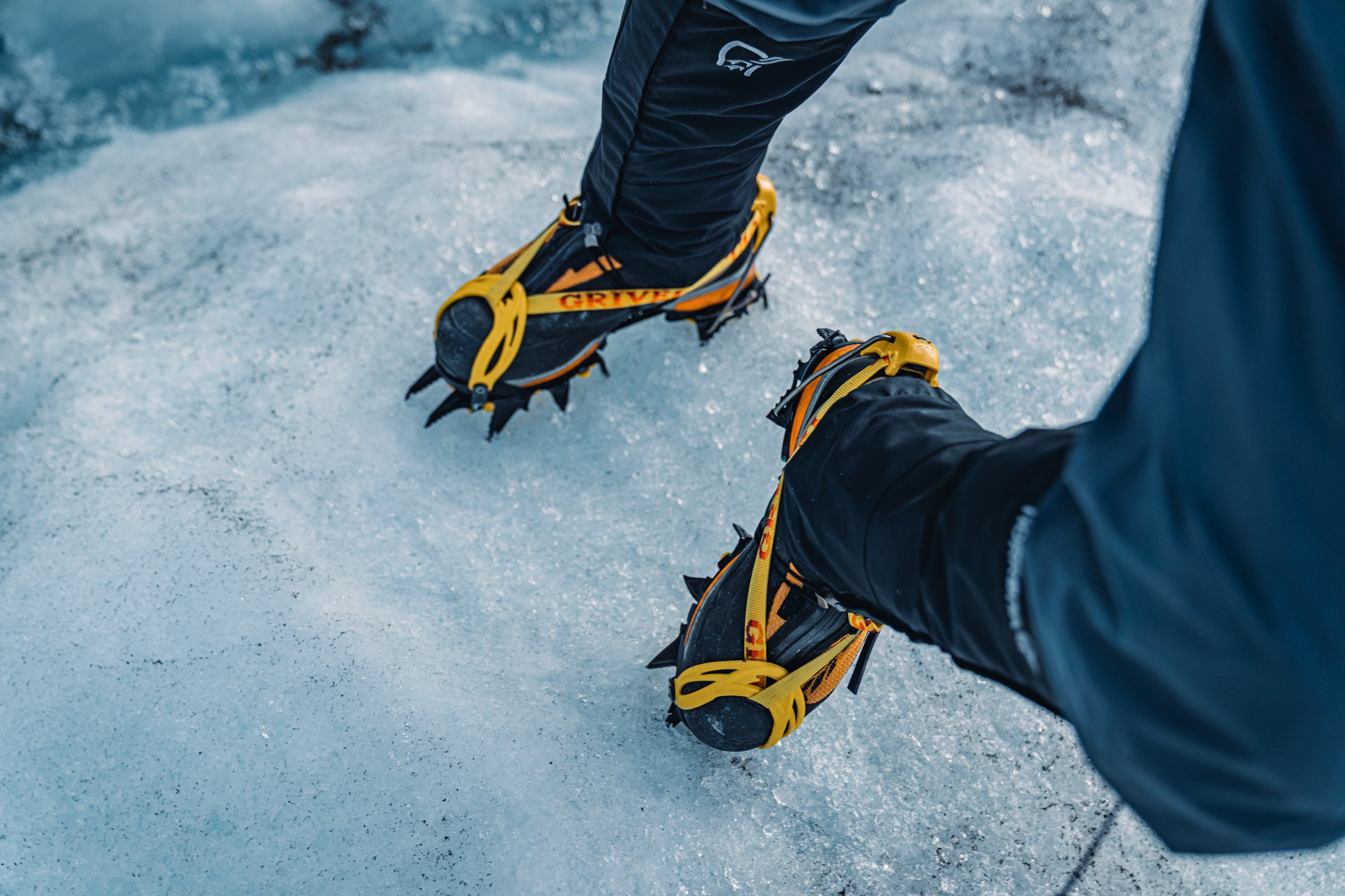 Climber showing their yellow ice cleats