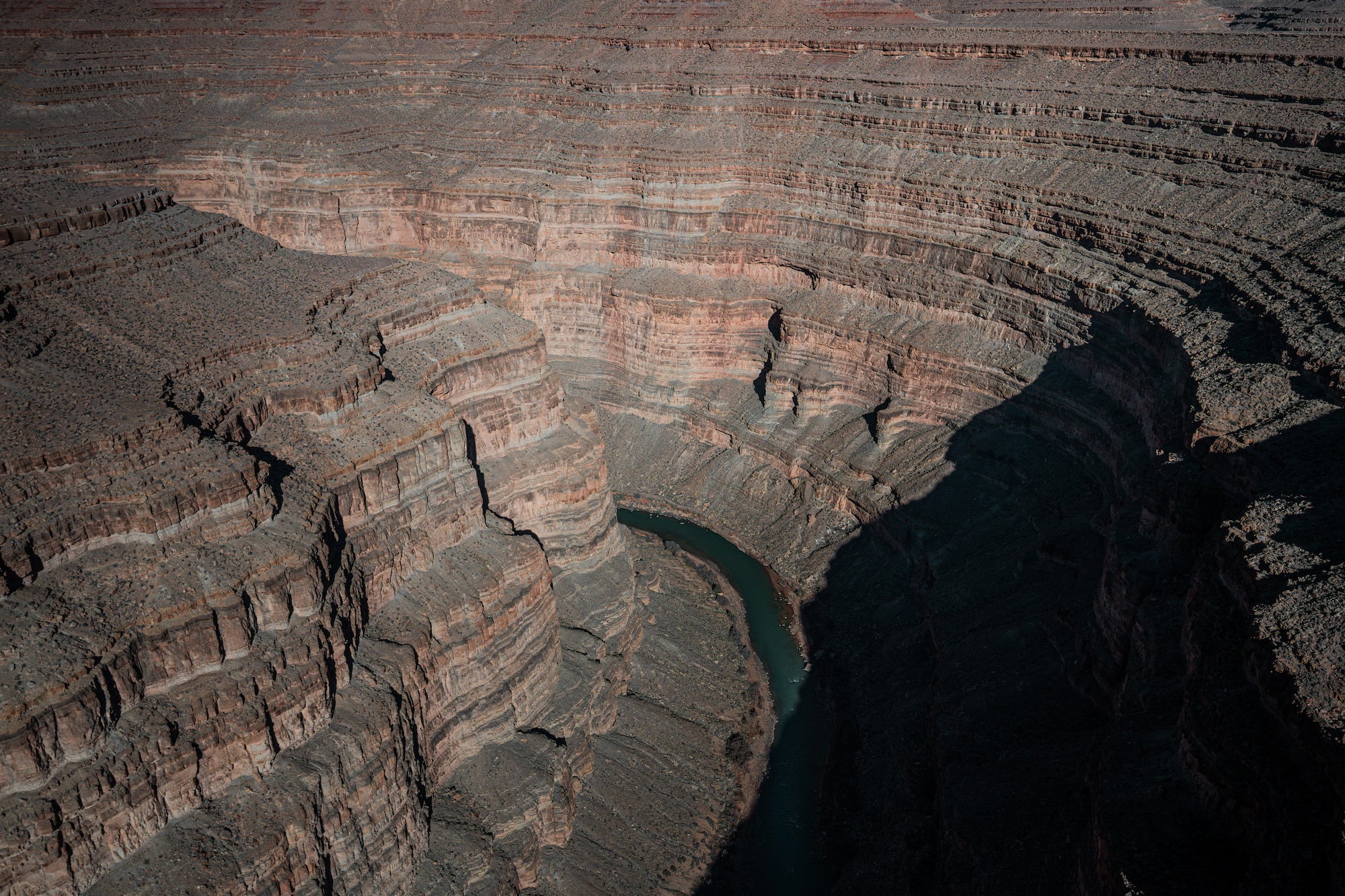 Aerial view of the San Juan River winding through a deep, layered red-rock canyon. Photograph by Sydney Smolla.