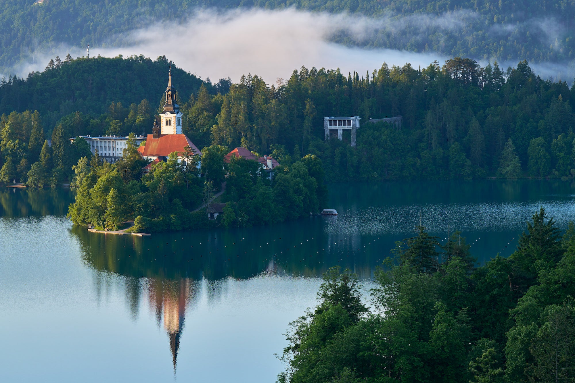 Lake with tree-covered island and castle