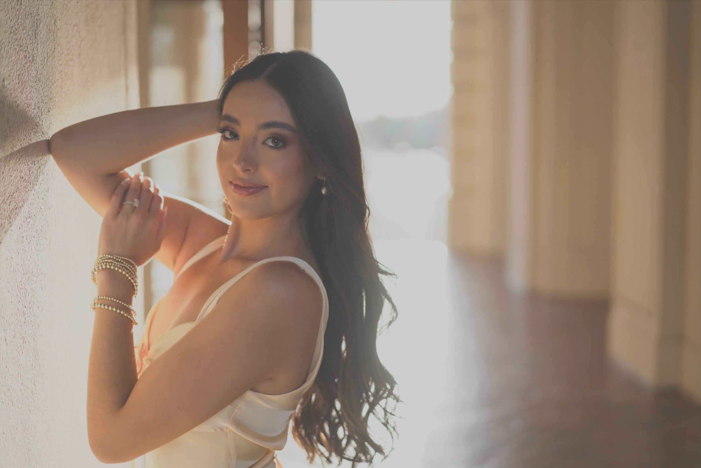 Woman posing with elbow on wall