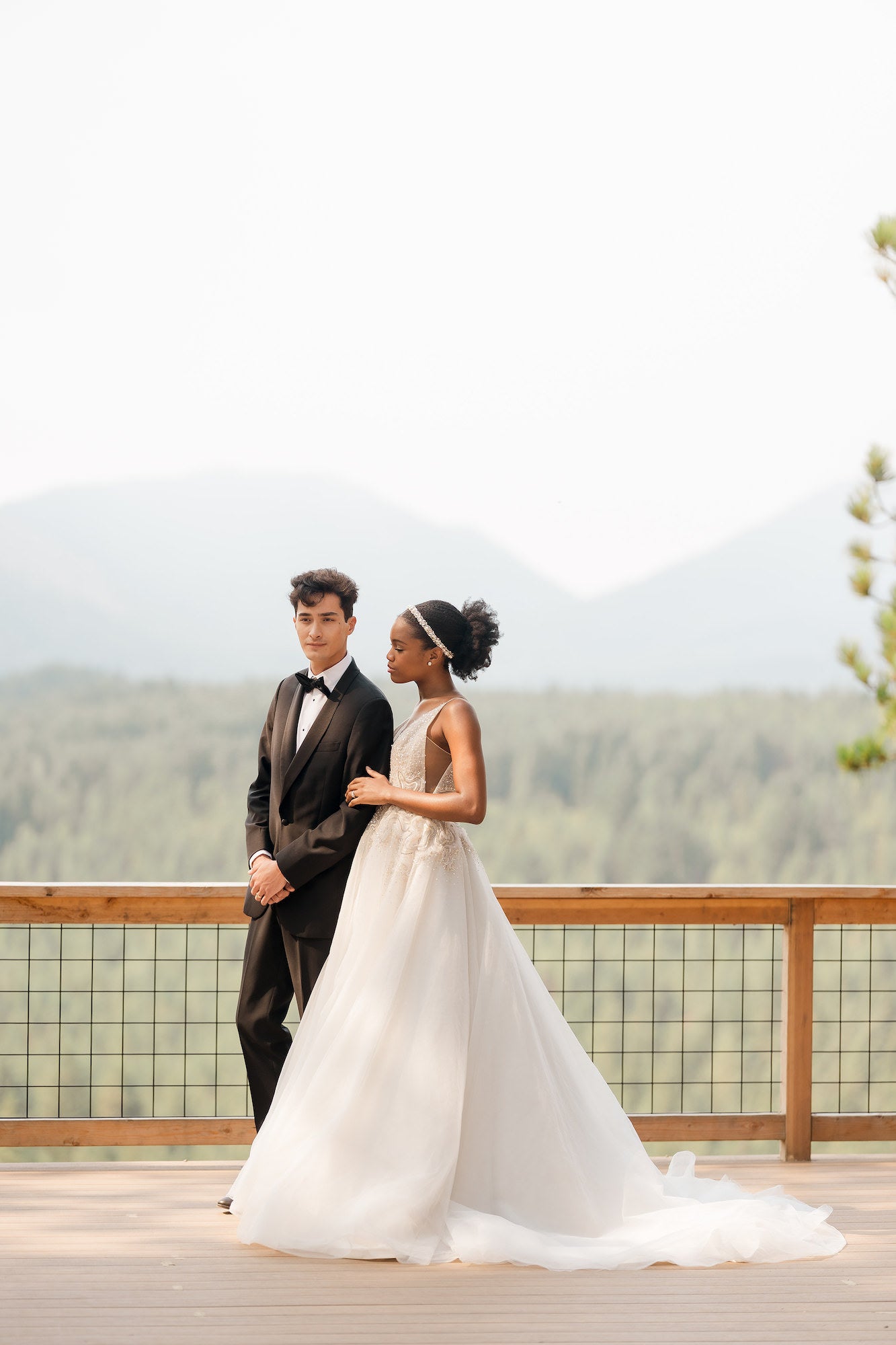Bride and groom standing on path in front of sweet forest landscape Bride and groom standing on path in front of sweet forest landscape