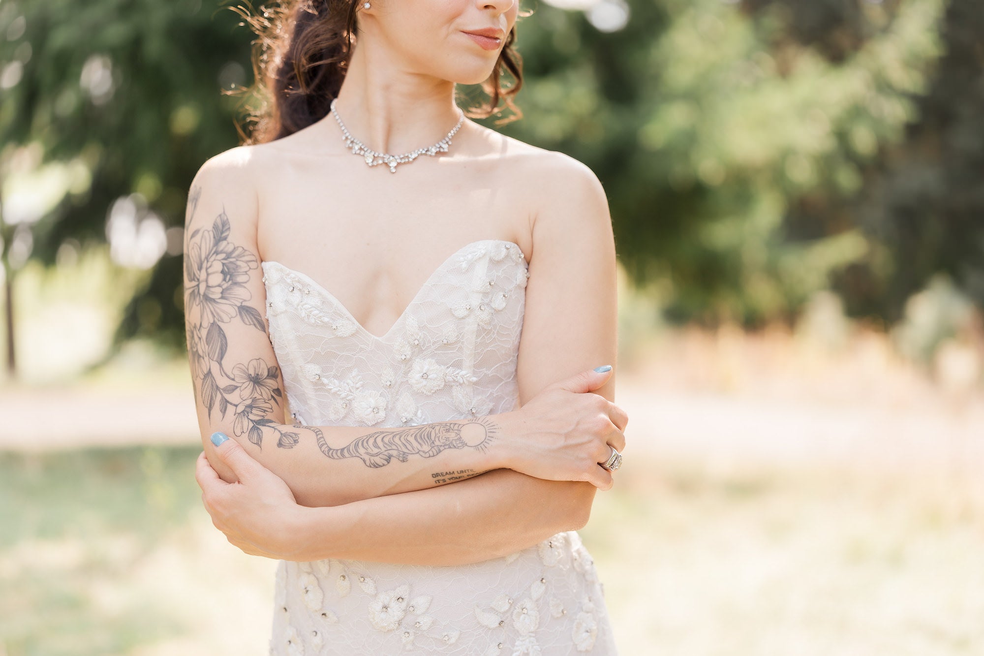Portrait of bride with her arms crossing each other in front of her wedding dress Portrait of bride with her arms crossing each other in front of her wedding dress