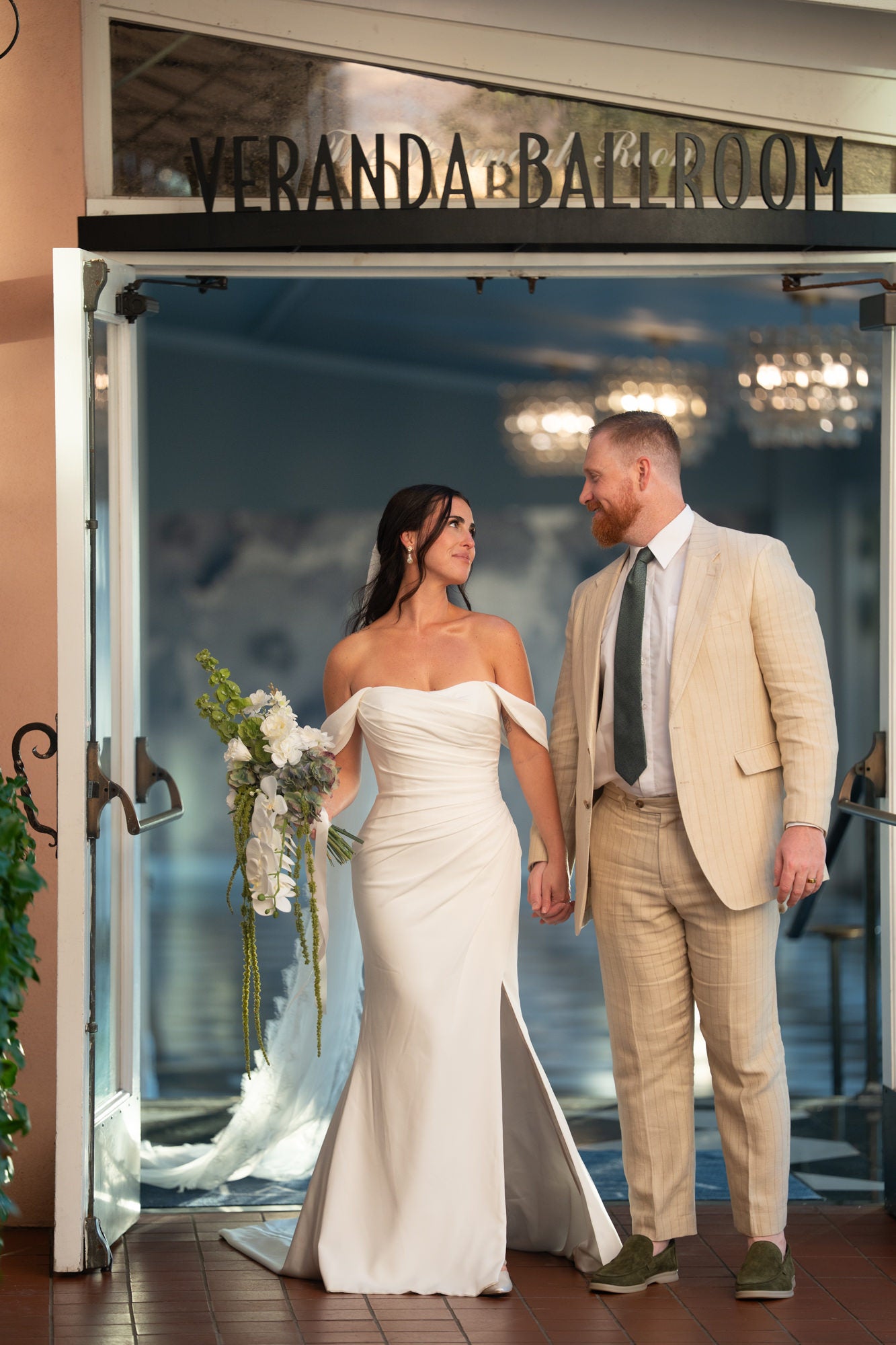Bride and groom walking through doorway of Veranda Ballroom Bride and groom walking through doorway of Veranda Ballroom