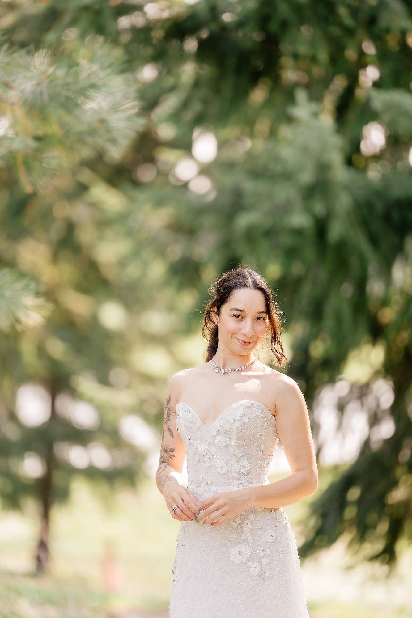 Portrait of bride standing in front of trees Portrait of bride standing in front of trees