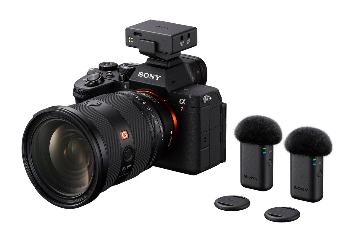 Sony Alpha 7R camera with 24-70mm G Master lens and ECM-W5 wireless microphone receiver and two transmitters on white.