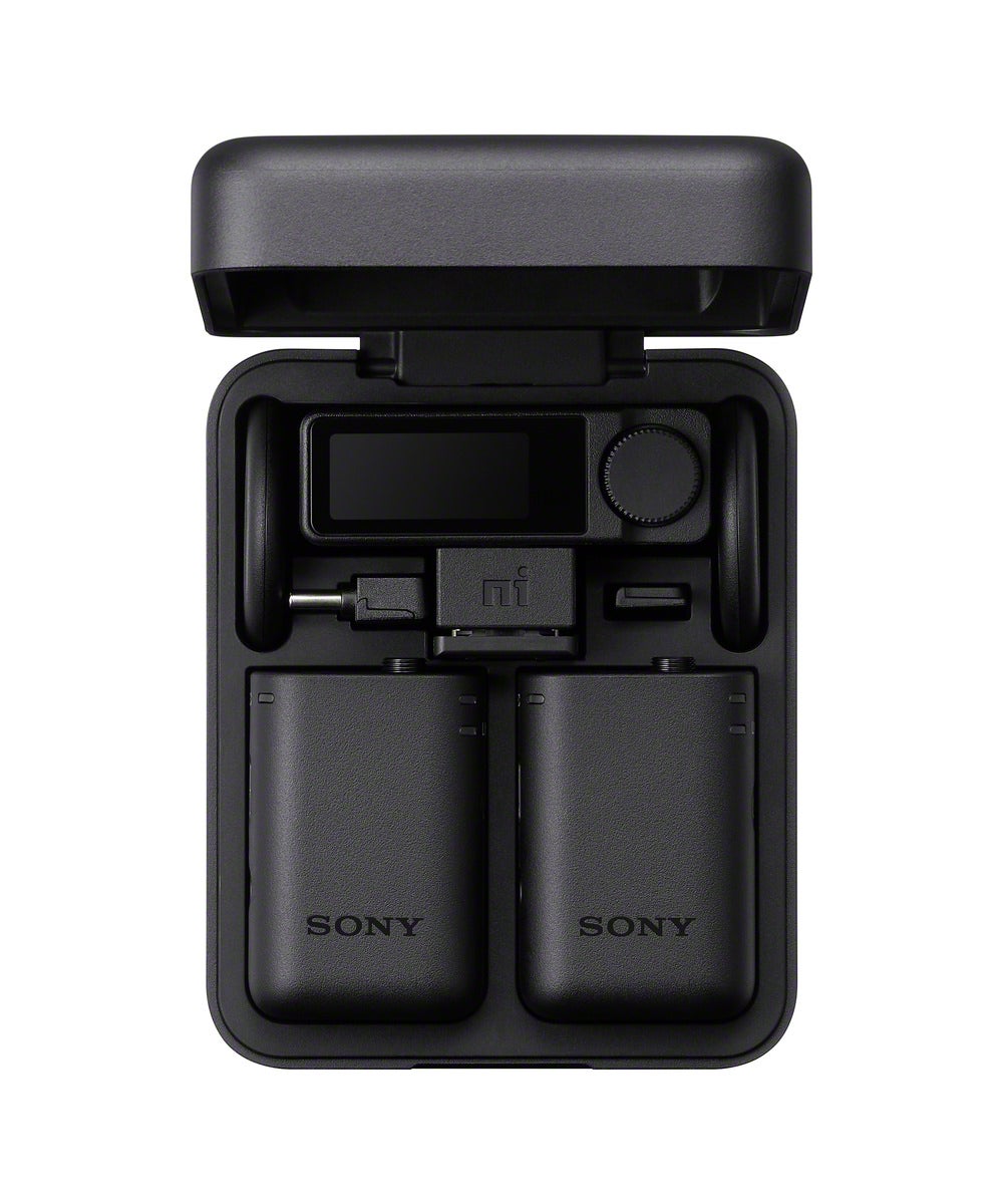 Sony ECM-W5 wireless microphone system in its open charging case with two transmitters and a receiver.