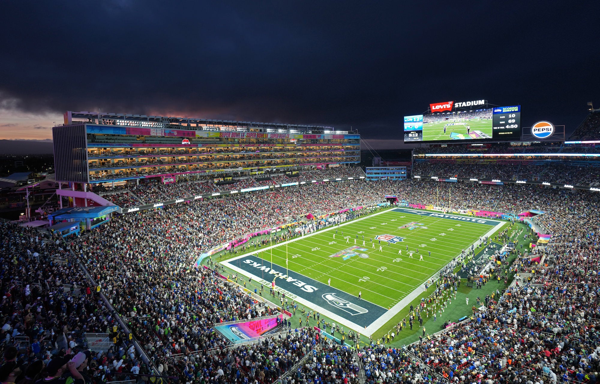 Panoramic night view of a packed Super Bowl stadium and illuminated field. Panoramic night view of a packed Super Bowl stadium and illuminated field.