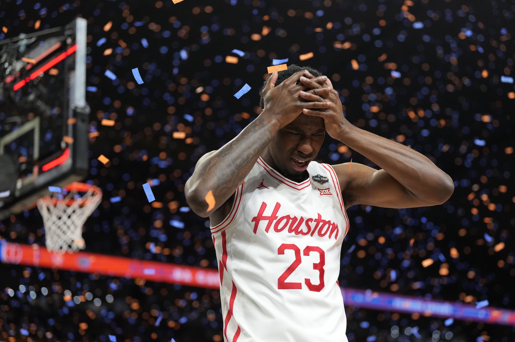 Houston player holds his head amid falling confetti after the final buzzer. Houston player holds his head amid falling confetti after the final buzzer.