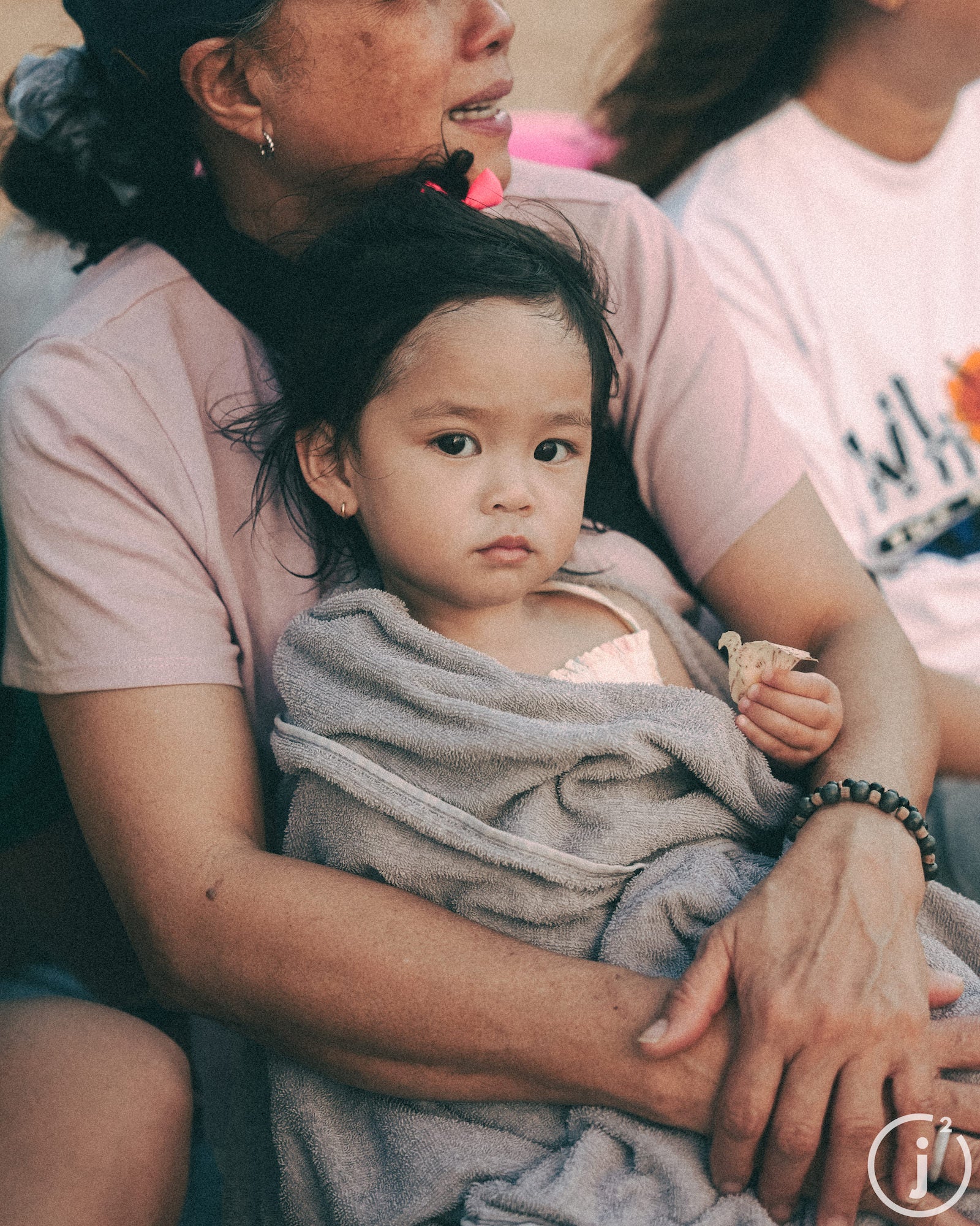 Little girl sitting on mom's lap