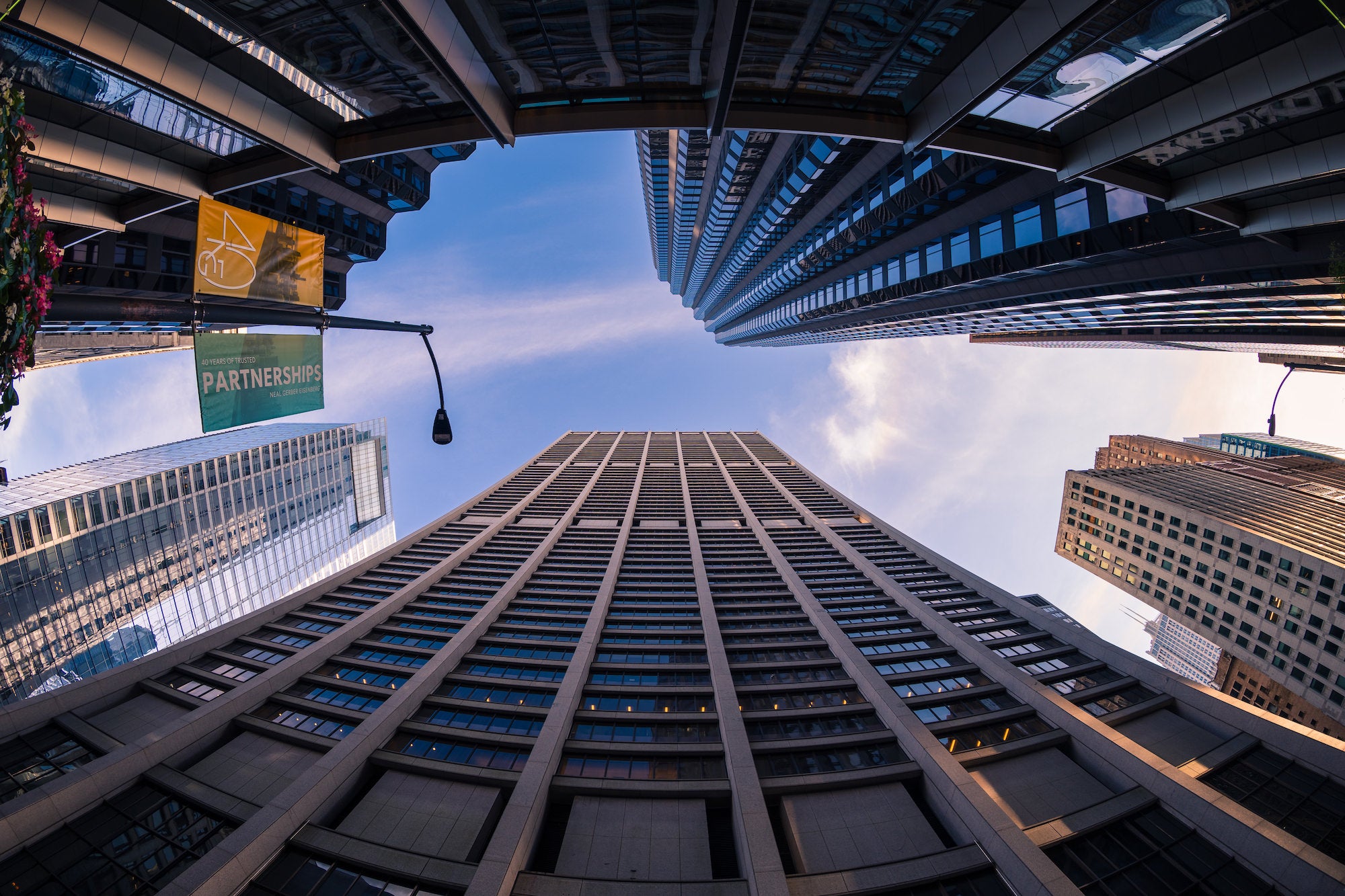 Fisheye view looking up at downtown high-rises against a pale blue sky. Photo by Mike Meyers. Alpha 1. 8-14mm f/3.5 Fisheye G. 1/200-sec. f/3.5. ISO 100.