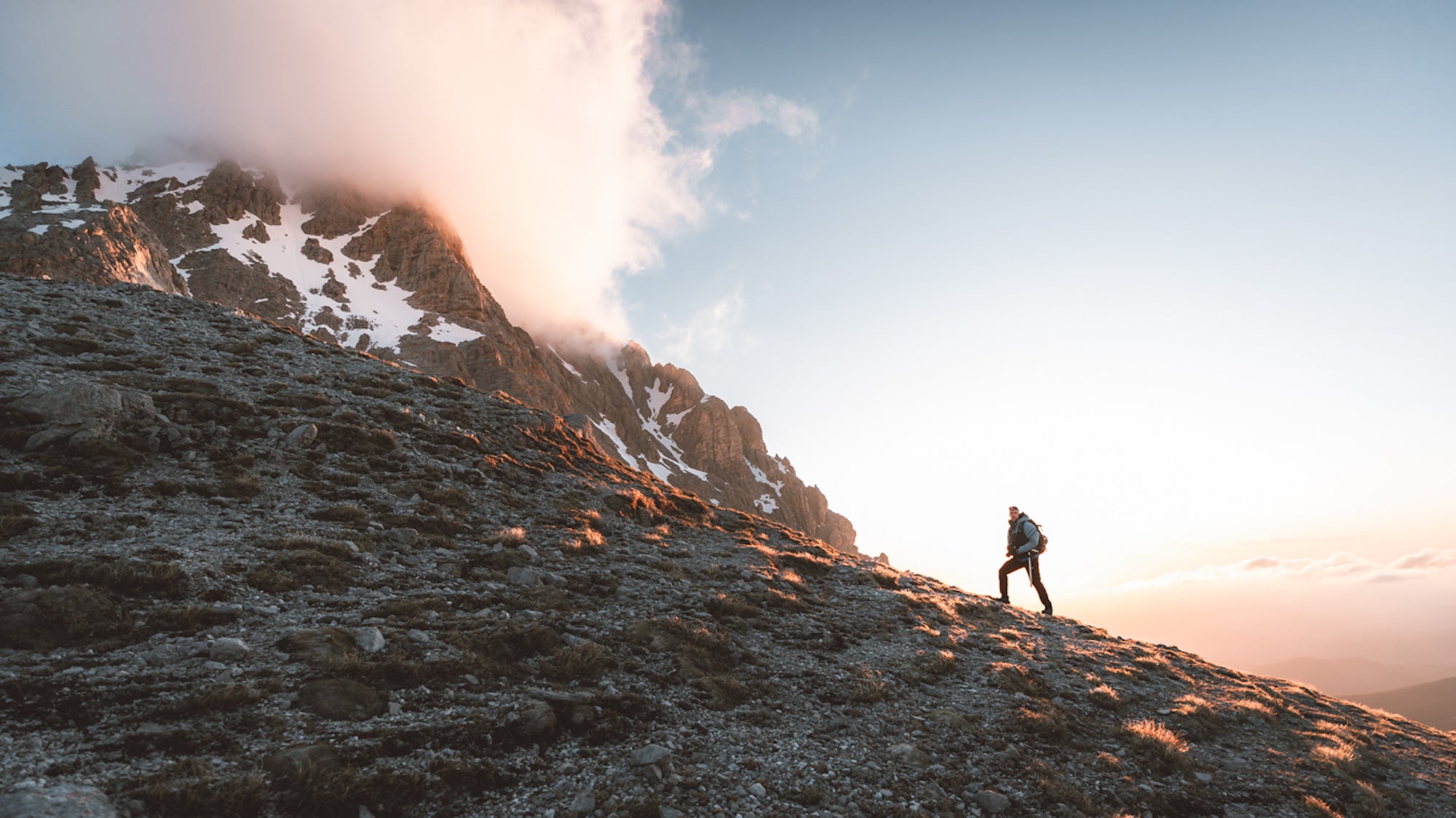 Person standing looking upward on a mountain