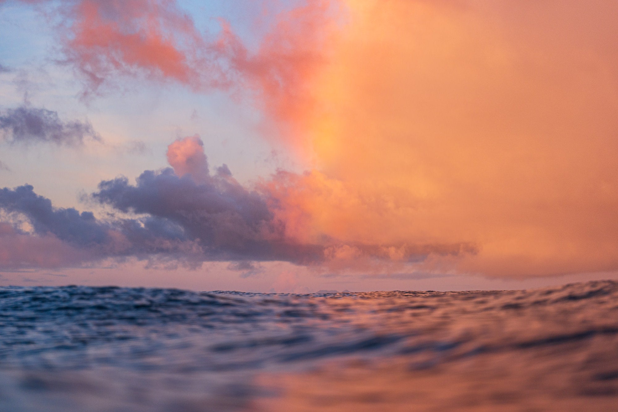 Eye level with the ocean looking out at a rainbow