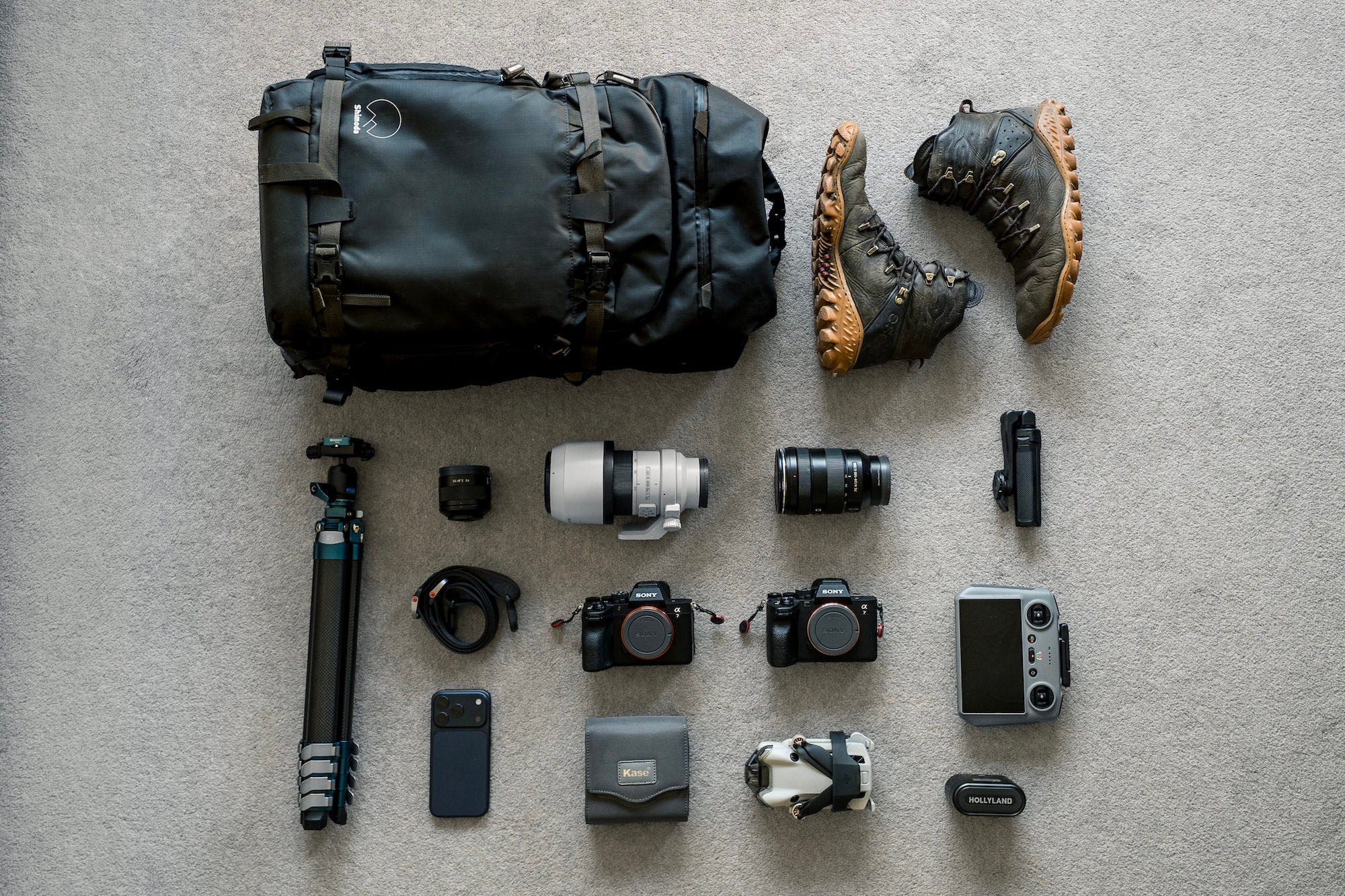 Landscape photographer Lee Cooper's complete Sony Alpha kit laid out flat: two Alpha bodies, telephoto zoom, prime lens, tripod, drone, Kase filters, and hiking boots. Landscape photographer Lee Cooper's complete Sony Alpha kit laid out flat: two Alpha bodies, telephoto zoom, prime lens, tripod, drone, Kase filters, and hiking boots.