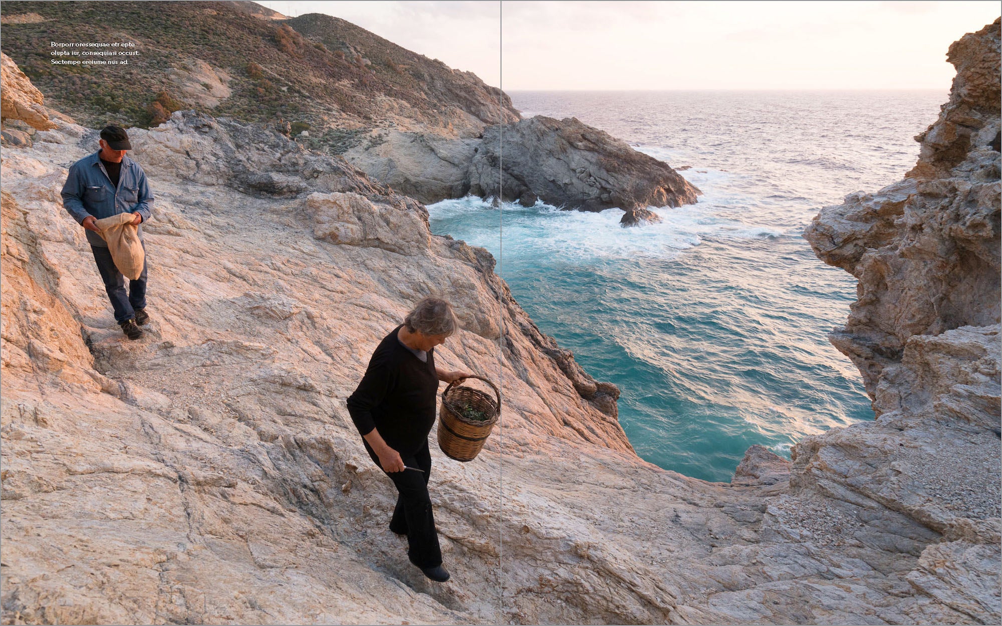 Two people walk along rocky seaside cliffs above turquoise waves at sunset. Two people walk along rocky seaside cliffs above turquoise waves at sunset.