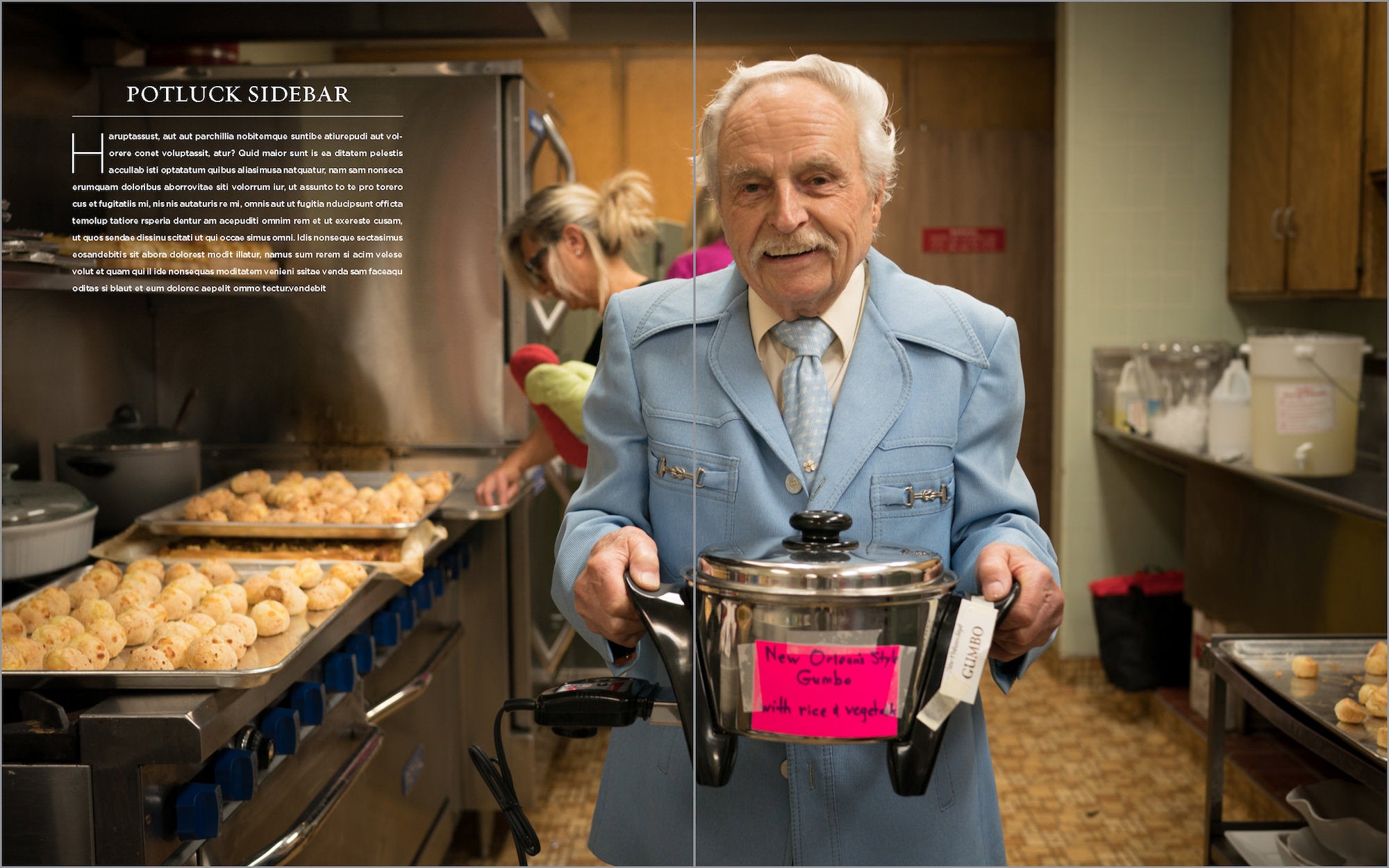 Man in a kitchen holds a pot labeled “gumbo” while trays of rolls bake and another cook works behind him. Man in a kitchen holds a pot labeled “gumbo” while trays of rolls bake and another cook works behind him.