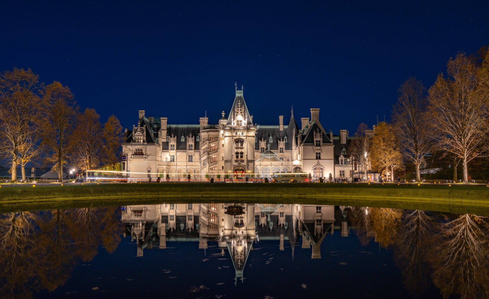 Biltmore facade at night reflected in a still pond