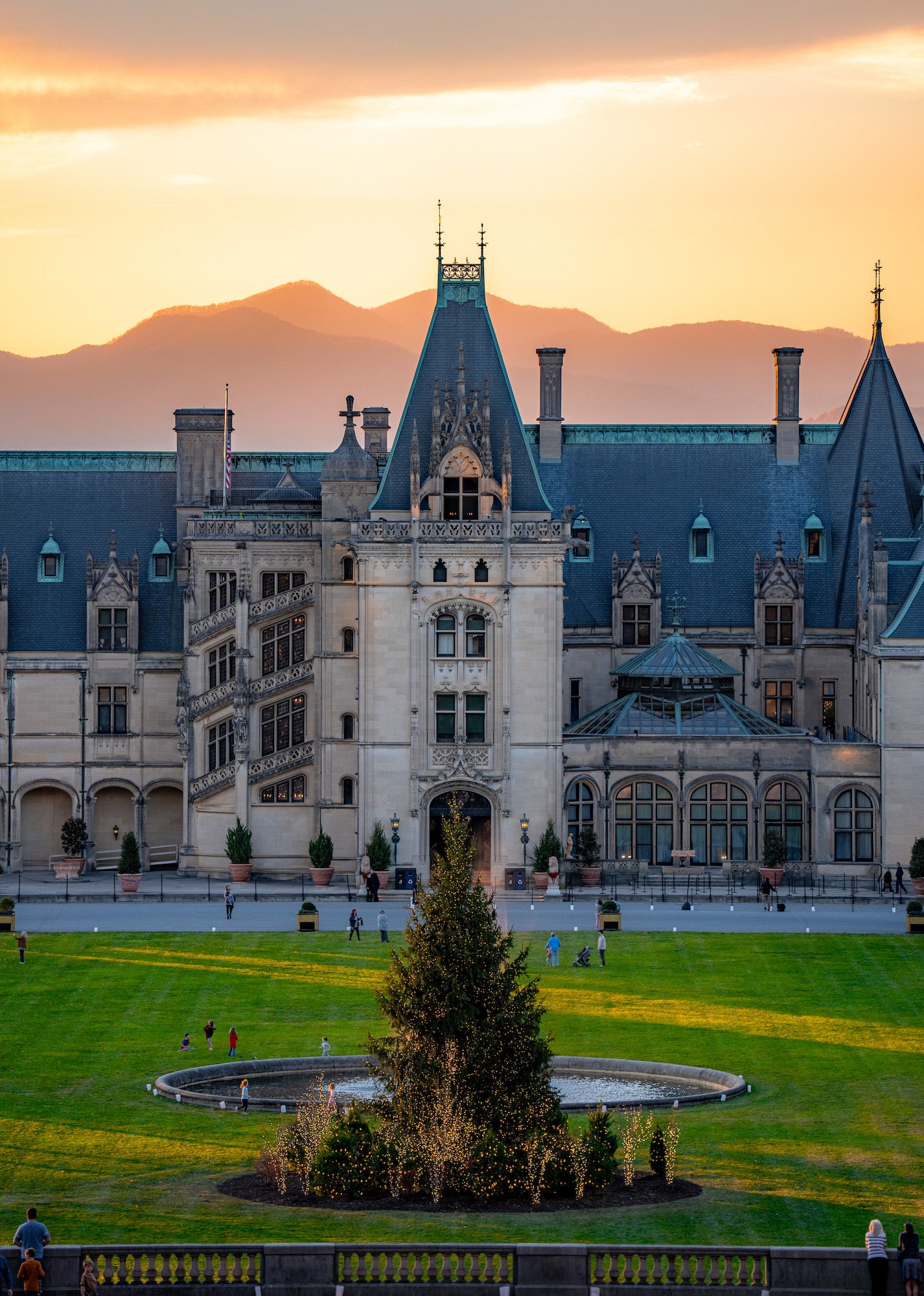 Biltmore front lawn with holiday tree at golden sunset