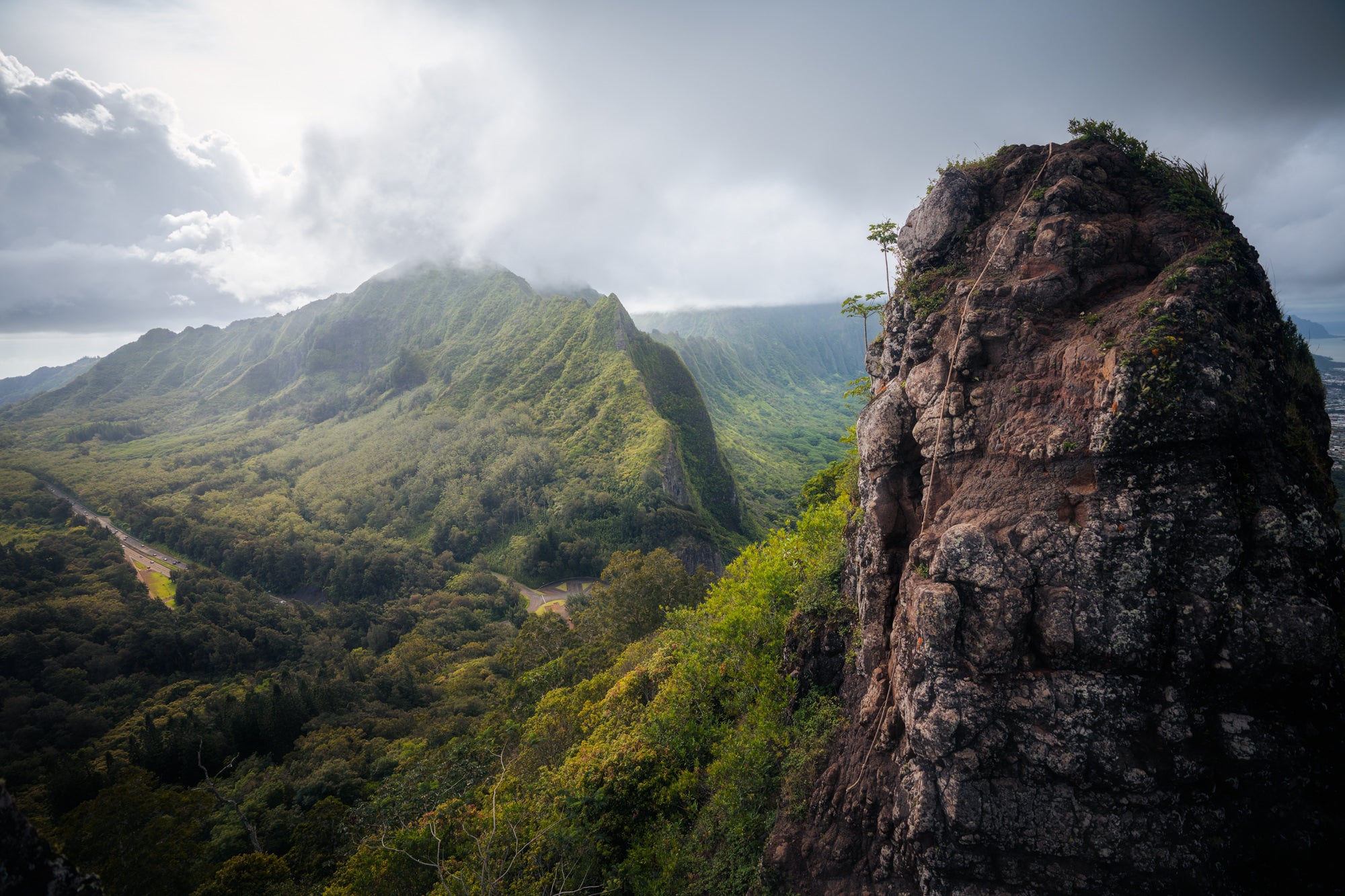 Lush green ridges and valley under low clouds on Oahu’s Ko‘olau Range, adventure landscape by Paul Clark.