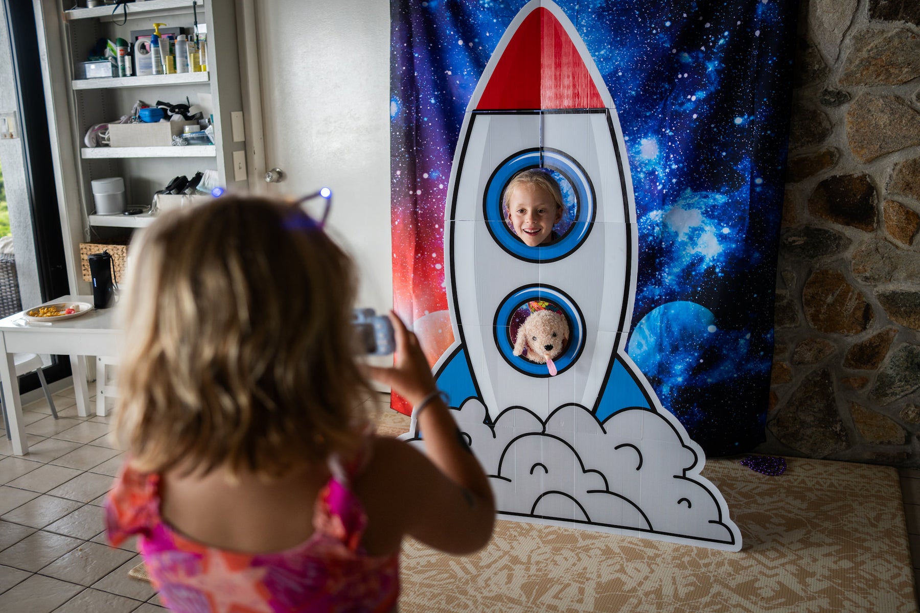 https://alphauniverseglobal.media.zestyio.com/space-themed-photo-booth-rocket-kids-taking-pictures.jpg?height=1200&fit=bounds